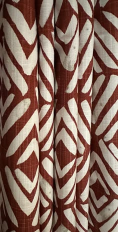 the curtain is red and white with an intricate pattern