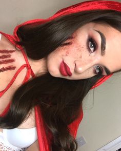 a woman with dark hair and red makeup