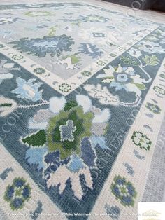 a blue and white rug with flowers on it