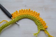 the crochet is being worked on with scissors