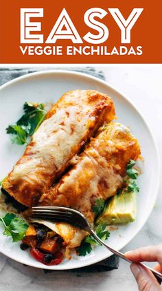 an easy vegetarian enchiladas recipe on a white plate with a fork in it