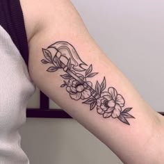 a woman's arm with flowers on it