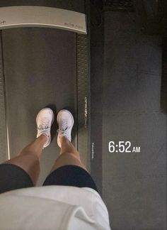 a person standing on a bathroom scale with their feet in the air and measurements below