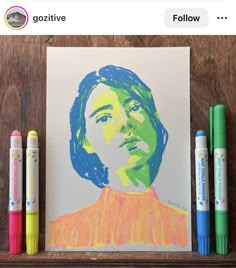 some crayons are next to a drawing of a woman