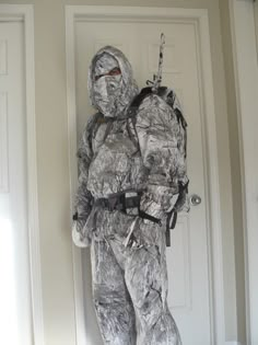 a paper mache man is standing in front of a door with his back to the camera