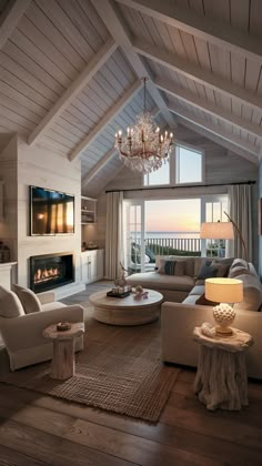 a living room filled with furniture and a chandelier hanging from the ceiling over a fire place