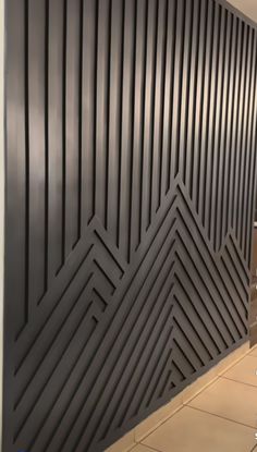 the wall is painted black and has an interesting pattern on it's sidewall