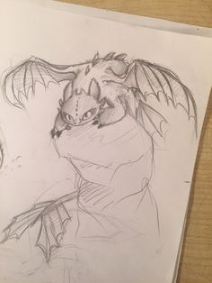 a pencil drawing of a dragon on paper