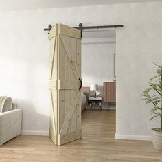 a living room with a couch, chair and sliding barn door that opens to the bedroom