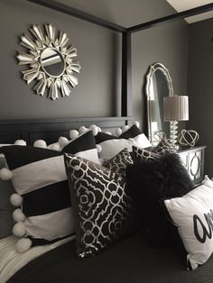 black and white pillows on a bed in a bedroom