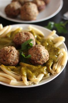 pasta with meatballs and pesto sauce on it