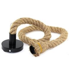 a rope with a black hook on it next to a white background and an object in the foreground