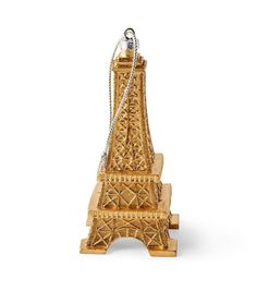 a wooden statue of the eiffel tower with a chain hanging from it's side