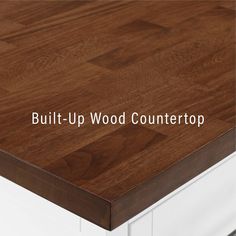 the words built - up wood countertop are in white lettering on a brown and white background