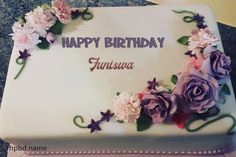 a birthday cake decorated with flowers and the words happy birthday my name here