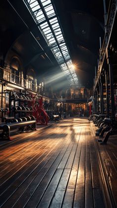 an empty gym with benches and lights shining down on the floor in front of them