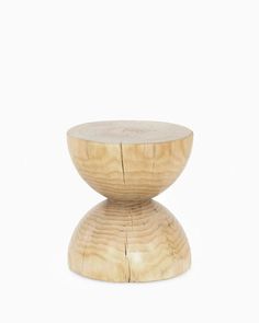 a wooden stool sitting on top of a white floor