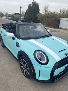 a blue and white car parked on the street