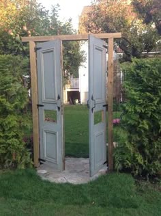 an open door in the middle of a garden