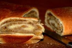 a sliced loaf of bread sitting on top of a cutting board next to a knife