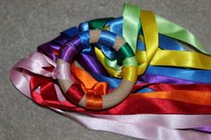 there are many ribbons tied together on the floor and one is multicolored with different colors