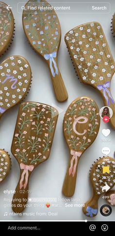 wooden spoons decorated with flowers and ribbons are arranged in the shape of paddles