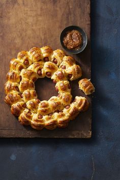 hot cross buns on a cutting board with dipping sauce