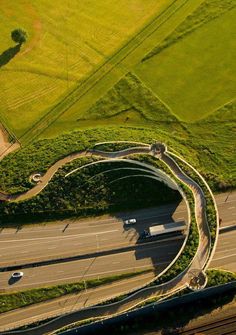 an aerial view of a highway with cars driving on it