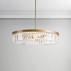 a chandelier hanging from the ceiling in a room with white walls and flooring