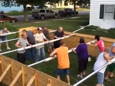 a group of people standing around in front of a house