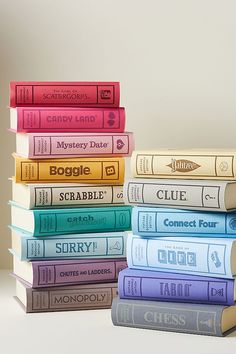 a stack of books sitting next to each other on top of a white countertop