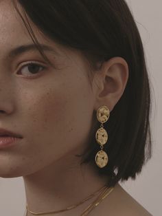 a close up of a person wearing gold jewelry