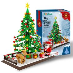 the lego christmas tree is set up in front of a box with presents on it