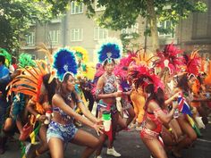 several women in colorful costumes dancing on the street