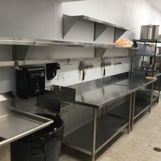 a commercial kitchen with stainless steel counters and appliances