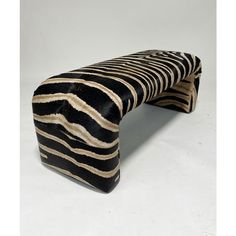 a zebra print bench sitting on top of a white floor