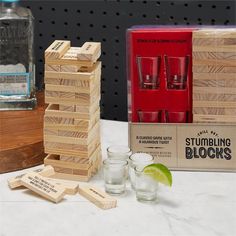 the wooden blocks are next to glasses and a box with labels that say stumping blocks