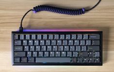 a computer keyboard with a cord attached to it