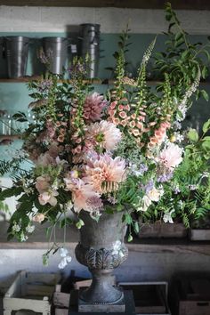 a vase filled with lots of flowers on top of a table