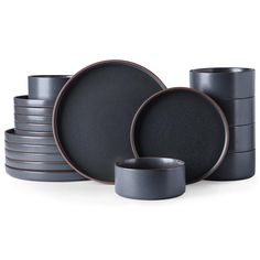 black and grey dinnerware is stacked on top of each other