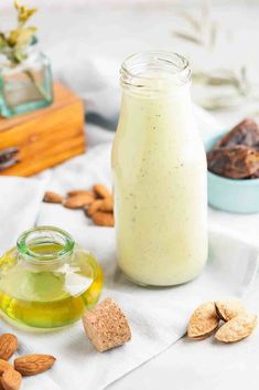 a jar filled with almonds next to other nuts