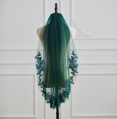 the back of a wig with green hair on a mannequin