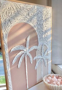 a white paper art with palm trees on it and a bowl of marshmallows