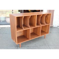 a wooden bookcase with six compartments on the front