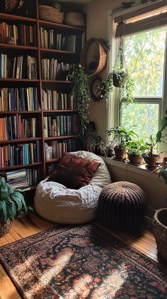 a room filled with lots of plants and bookshelves next to a large window