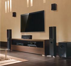 a flat screen tv sitting on top of a wooden entertainment center in a living room