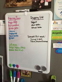 a white board with writing on it and magnets attached to the back of it