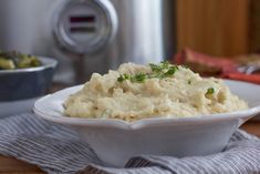 mashed potatoes in a white bowl on a table