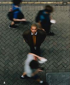 an overhead view of two men walking down the street with one man holding a frisbee