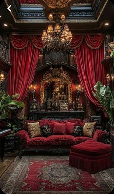 a living room filled with furniture and red drapes on the windows above it is a chandelier